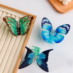 Three-piece set of butterfly hair claws in green and blue colors with acrylic acetate finish