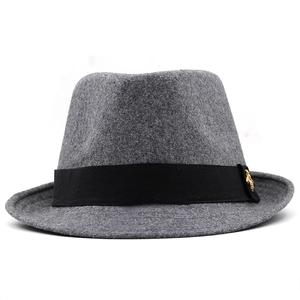 Detail of grey wool fedora hat featuring a black silk band with a gold bee metal buckle