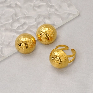 Detailed view of 18K gold plated hammered round earrings and matching ring set
