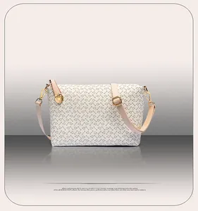 Detailed front view of crossbody bag with golden geometric pattern and ring zipper