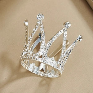 Detailed shot of a silver alloy mini crown with sparkling rhinestones and pointed design