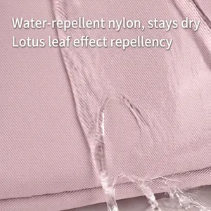 Water-resistant pink nylon fabric detail of a large capacity travel backpack for women