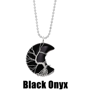 Macro shot of silver wire tree of life wrapped on crescent black onyx pendant necklace