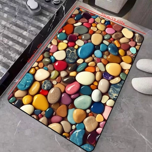 Detail view of colorful pebble bath mat measuring 80x50cm on marble floor