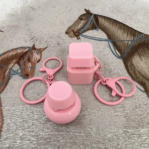 Pink cube and dome mechanical keycap fidget keychain toys on embroidered textile