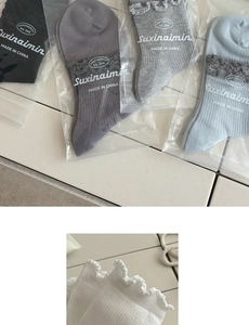 Detailed close-up of ribbed cotton socks with scalloped lace trim in multiple colors