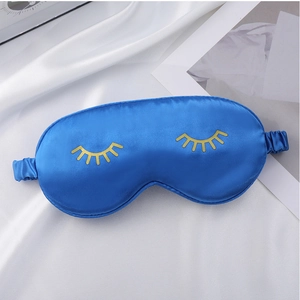 Blue silk sleep mask with gold eyelash embroidery, soft and comfortable for daily use.