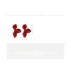 Detail of dark red textured metal flower petal earrings with high gloss spray finish