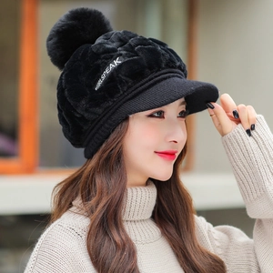 Women's warm black plush winter hat with a fluffy pompom and stylish brim design