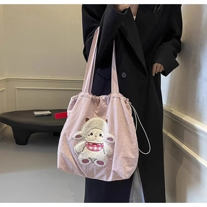Detail of pink canvas tote bag with a cute 3D cartoon sheep patch and drawstring closure