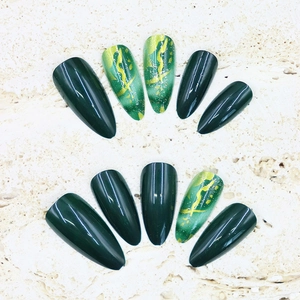 Glossy long almond press-on nails in forest green and gold marble art design