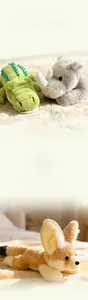 Close-up of soft plush crocodile and fox toys with fluffy texture on a cozy rug
