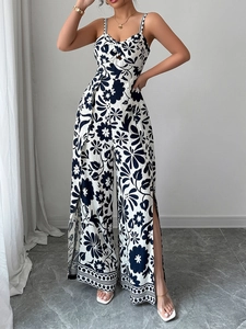 Detail view of wide-leg jumpsuit showing elegant blue floral pattern and side leg slits