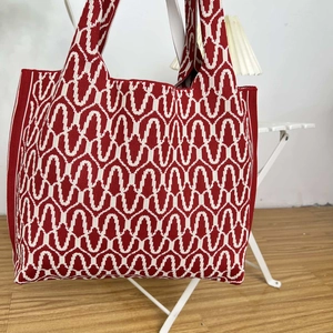 Close-up of the red and white wavy geometric pattern on this knitted tote bag