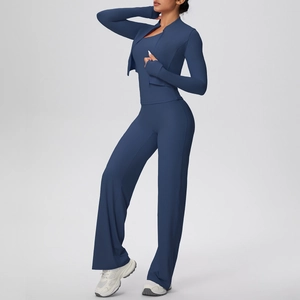Detail of navy blue three-piece yoga set with zip jacket, vest and wide-leg pants