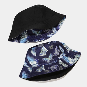 Reversible bucket hat with butterfly pattern and solid black side for sun protection
