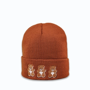Detail of three small bear embroidery on caramel brown cuffed knitted beanie hat