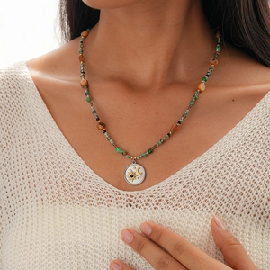 Detail of bohemian necklace featuring colorful stone beads and sun moon pendant
