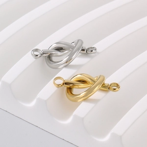 Macro detail of heart-shaped gold and silver stainless steel jewelry connectors