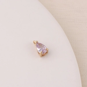 Macro view of water drop purple zircon pendant with gold plated setting for DIY jewelry