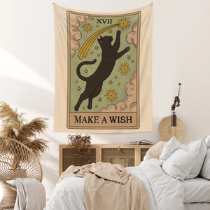 Detail showing tarot XVII star cat tapestry with make a wish text in cozy bedroom setting