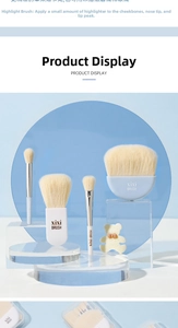 Detail view of mini makeup brushes with soft bristles and brand logo on acrylic props