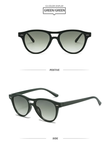 Close-up of green aviator sunglasses with double bridge and silver rivet details