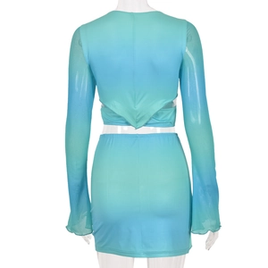 Rear view of women's two-piece set featuring blue-green gradient crop top and mini skirt