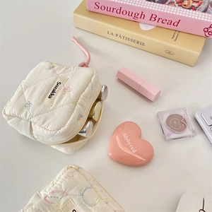 Quilted cotton pouch with floral embroidery and pink zipper lanyard detail