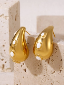 Detail of 18K gold-plated teardrop earrings with pavé zircons on a textured stone base