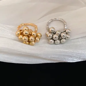 Irregular spherical clustered open ring set in polished gold and silver finishes