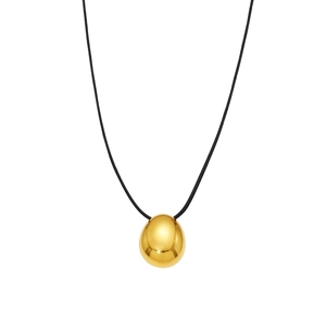 Polished gold oval pendant on a black cord necklace with a minimalist geometric design