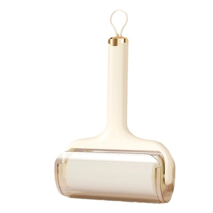 Washable sticky lint roller with a sleek off-white handle and gold trim for pet hair removal