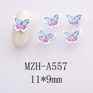 Macro shot of 11x9mm gradient butterfly nail charms with silver metal frame on a nail