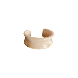 Minimalist resin open cuff bracelet with beige marble texture on white background