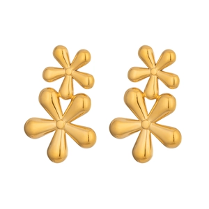 Detailed macro shot of golden double-layer flower earrings with a polished metal finish