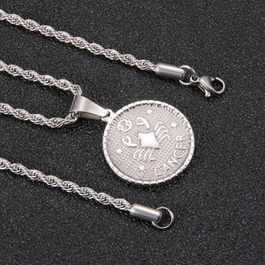 Detailed close-up of a silver zodiac pendant necklace featuring the Cancer crab and stars