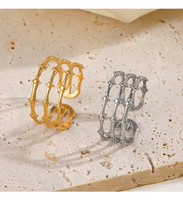 Detail of layered stainless steel rings with dot textures in gold and silver finish