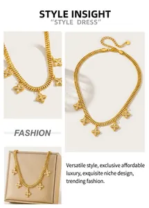 Detailed view of gold plated snake chain necklace with five zircon clover pendants