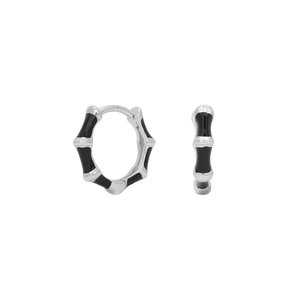 Detail view of silver bamboo hoop earrings with black enamel drip oil finish