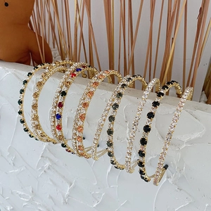 Close-up of Baroque headbands with rhinestones and crystals on white stone surface