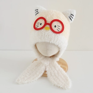 Detailed macro view of soft coral fleece texture and red eyeglass design on kids plush hat