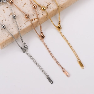 Three-color stainless steel snake chain bracelets with beads on travertine stone