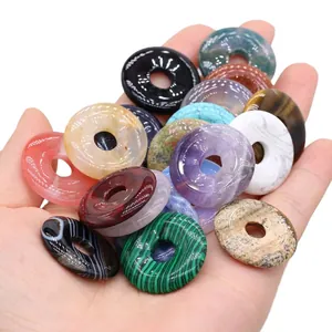 Polished natural crystal donut pendants in various colorful gemstone materials for DIY jewelry