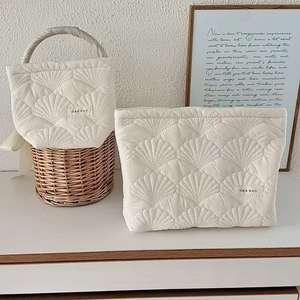 Minimalist white quilted shell makeup bag set with a handle bag and flat pouch