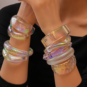 Macro detail of iridescent acrylic bangles with textured patterns and aurora visual effect