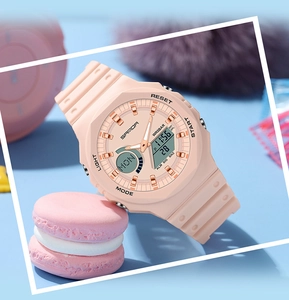 Detail of pink dual-display electronic watch with 5BAR water resistance on pastel background