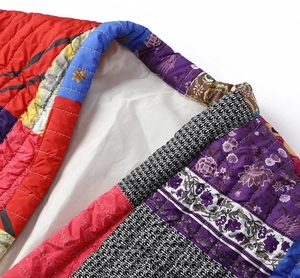 Close-up of quilted floral cotton vest showing neckline stitching and fabric texture