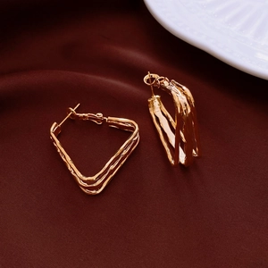 Detailed view of gold square geometric earrings with textured irregular triangle design