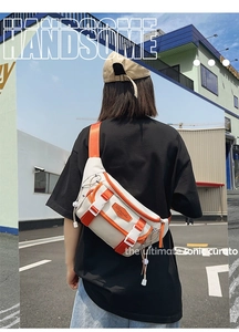 Detail view of functional beige chest bag with orange straps and tactical buckles